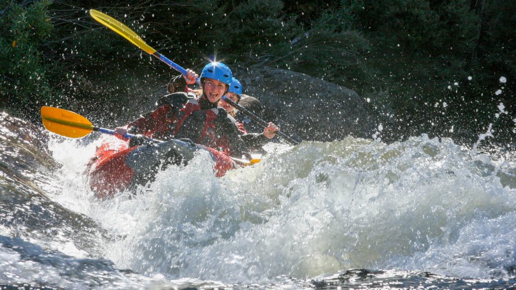 Photo of two students on a kayak