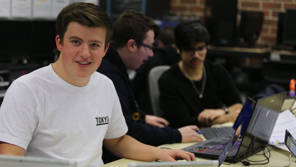 Image: A college student works on a laptop. Image courtesy of Hobart College (2021).